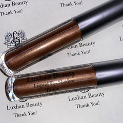 Liquid eyeshadow in taupe with metallic finish and Luxhan Beauty branding on tubes
