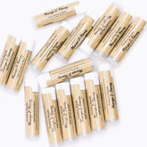 Lip balm tubes, tan paper, white caps, Country Woods brand name visible