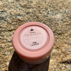Eyeshadow compact in pink and white with Disney Princess branding and text "Colourpop" visible
