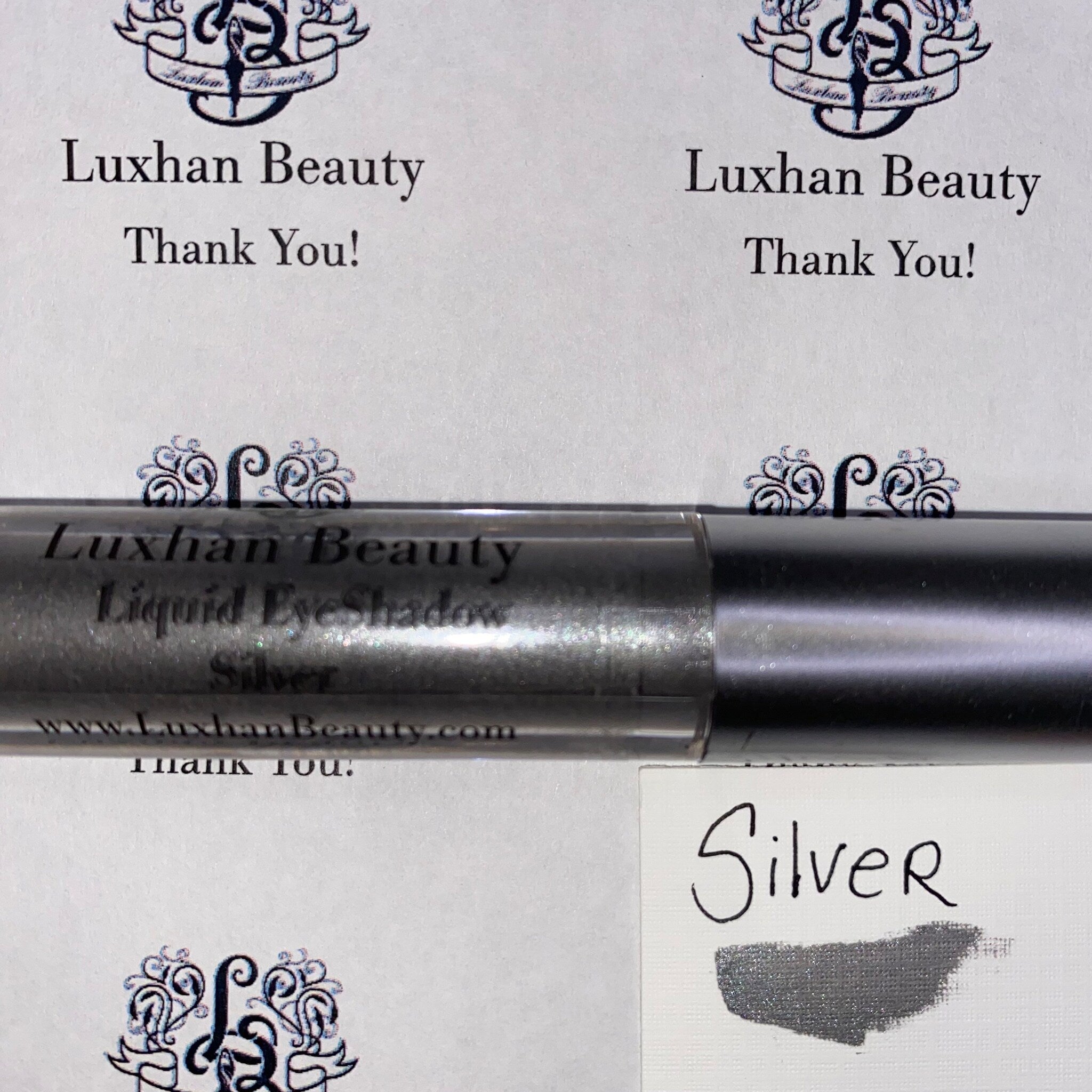 Liquid Eyeshadow silver metallic tube with silver swatch, Luxhan Beauty brand