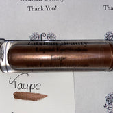 Liquid Eyeshadow metallic taupe shimmer in clear tube, Luxhan Beauty label visible