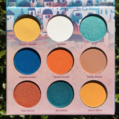 Eyeshadow palette with multiple colors, including blue, orange, and yellow, Mavie. Cosmetics brand