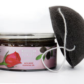 Facial cleanser with a black sponge and white string, AL HOOR jar with text and rose image