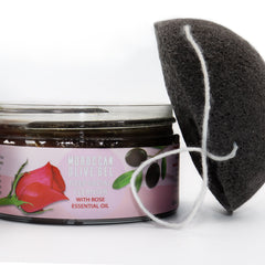 Facial cleanser with a black sponge and white string, AL HOOR jar with text and rose image