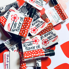Lip safe flavor oil with red heart pattern and black and white label, ButterCress brand text visible