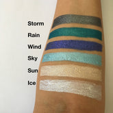 Eye shadow swatches with metallic finish in various colors, applied on skin