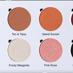 Close-up of vibrant matte and shimmery eyeshadows in warm sunset hues with eco-friendly cardboard packaging