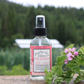 Toner bottle with black cap, clear glass, and pink label with Mountain Valley Botanics text