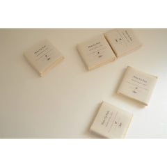 Make up pads in beige, rectangular packs, with visible branding and text on white surface