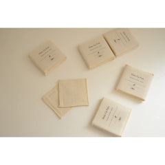 Make up pads in beige cotton fabric with printed packaging, several pads shown