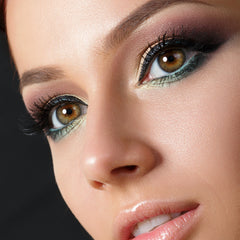 Eye makeup with brown and teal eyeshadow, black eyeliner, and long eyelashes on a face