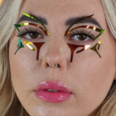 Face decals with holographic gold, green, and brown geometric shapes applied around eyes