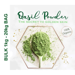 Close-up of golden-brown Qasil powder in a wooden bowl with a natural bristle brush for skincare application