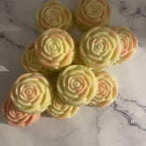 Luxury oval-shaped watermelon shea butter lotion bar in gold foil wrapping on marble surface