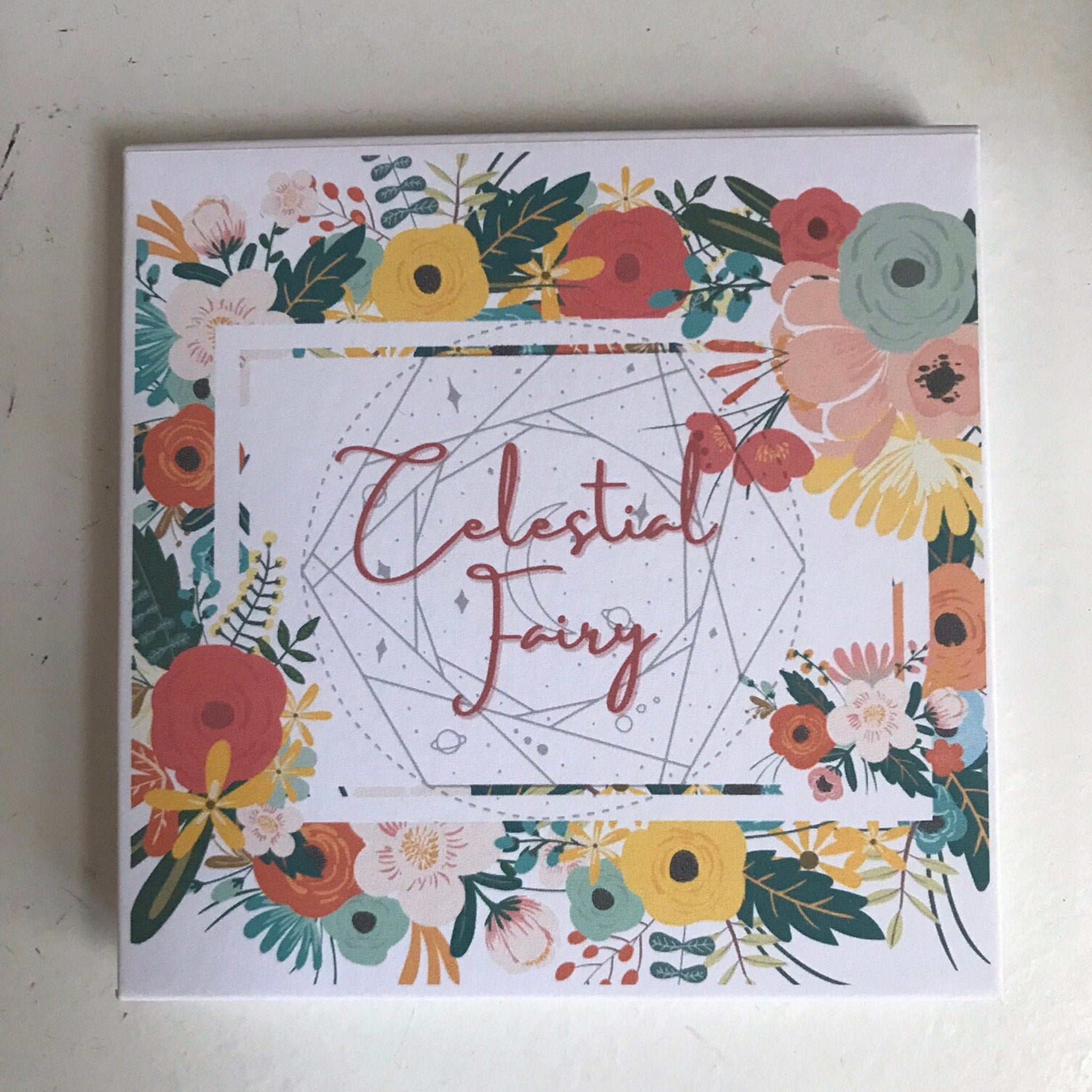 Eyeshadow palette floral print box with "Celestial Fairy" text and colorful flowers