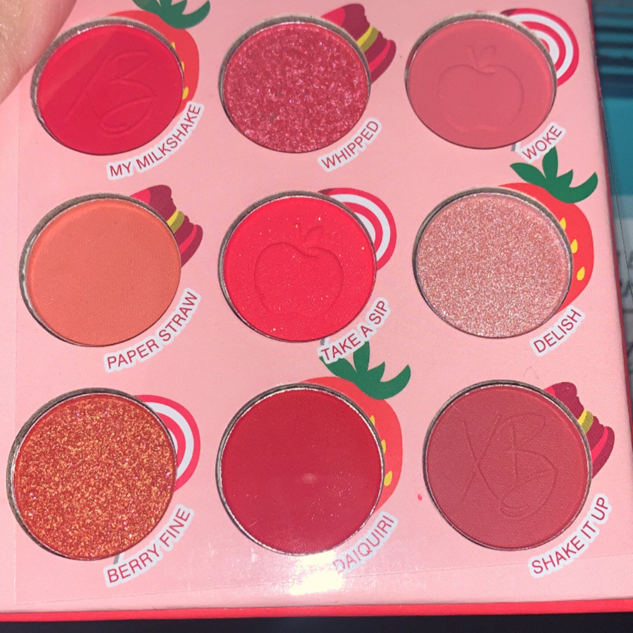 Side view of Sweet Dessert Eyeshadow Palette showing 12 vibrant powder shades in circular pans with glossy packaging