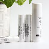 Peppermint lip balm tubes, white, with black text, Gugma Beauty branding visible