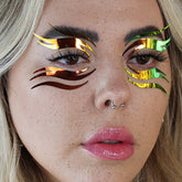 Face makeup graphic liner with holographic iridescent material in eye design