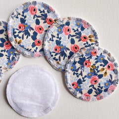 Reusable facial rounds with floral pattern, white backing, and serged edge detail