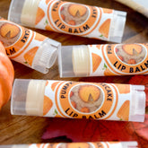Lip balm tubes with orange and white labels, clear plastic, and "Pumpkin Cheesecake Lip Balm" text