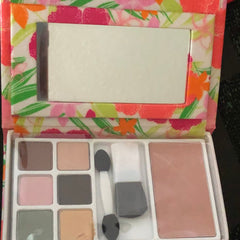 Makeup palette with floral pattern, pink and neutral eyeshadows, and mirror for application