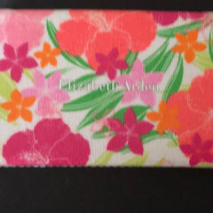 Floral pattern fabric with pink, orange, and green flowers, Elizabeth Arden text visible, white material