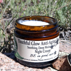 Close-up of rich, ivory-hued night cream in a sleek glass jar with bamboo lid, showcasing velvety texture