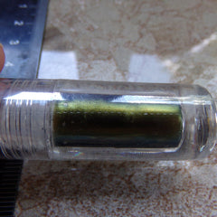 Side view of handmade mystery eyeshadow and lip color set showcasing textured powder surface and matching lip shade