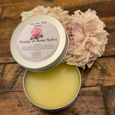Peony & Rose Salve in metal tin, yellow balm, with Fallingtree Farms label and pink flower