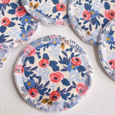 Reusable face rounds, floral fabric, blue and red pattern, white stitched edge