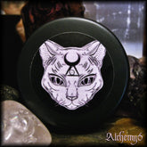 Lip balm container with black lid and cat face illustration, Alchemy6 brand