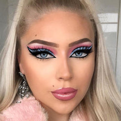 Makeup look with blue, pink, and black eyeshadow, blonde hair, and pink fur jacket.
