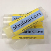 Lip balm tubes with yellow and blue labels, clear plastic, and Mandarin Clove text by Lee's Bees