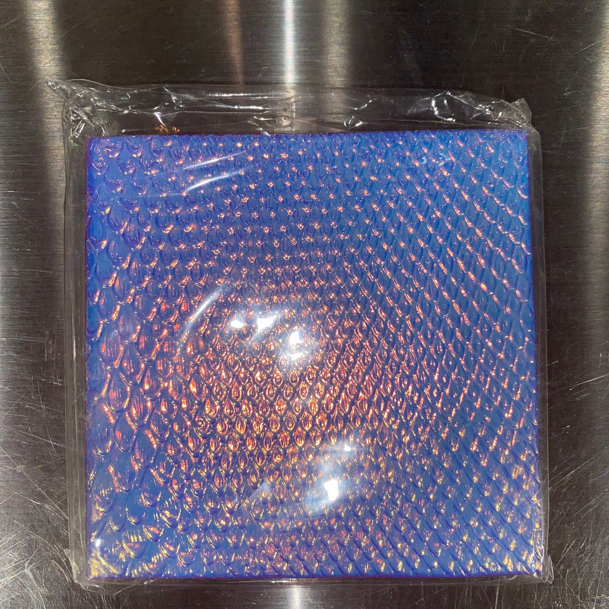 Square palette with nine vibrant eyeshadow pans in matte and shimmer finishes, arranged in three rows