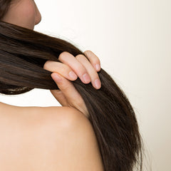 Dark brown hair held by hand, showing texture and length