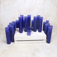 Lip balm tubes, blue plastic, cylindrical shape, with caps on a wooden crate.