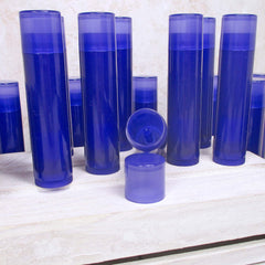 Lip balm tubes in blue plastic with open lid, grouped on white wooden surface
