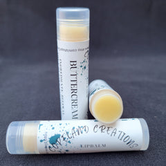 Lip balm tubes with white labels, yellow balm, and clear caps, Copeland Creations brand