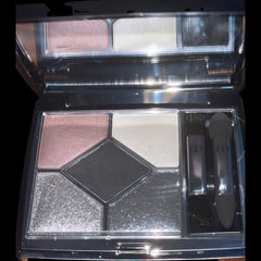 Close-up of makeup brush applying shimmering taupe Dior eyeshadow to eyelid crease