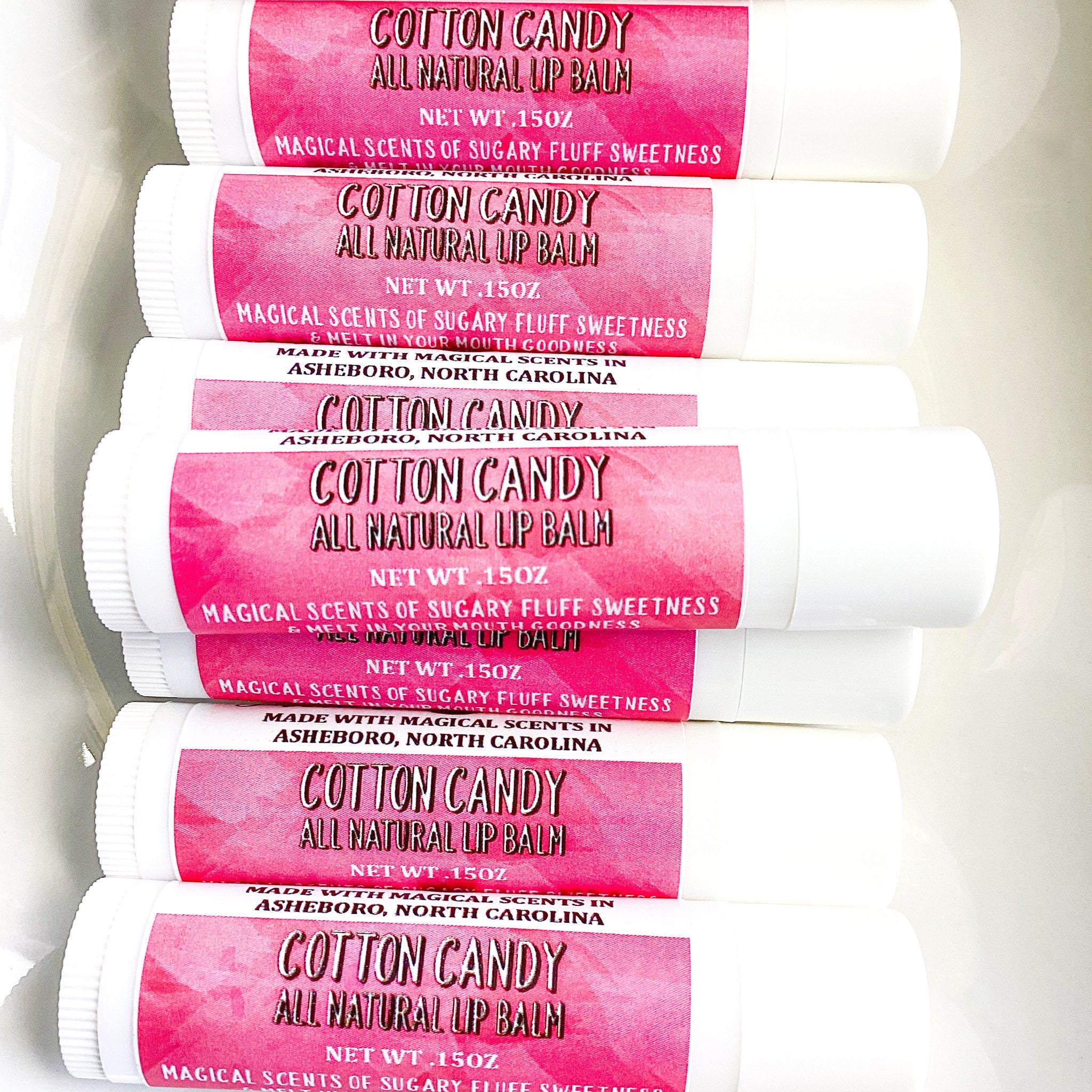 Lip balm tubes with pink label, white tube, Cotton Candy text visible