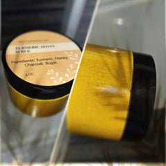 Close-up of golden turmeric scrub in a jar with organic texture and visible exfoliating particles