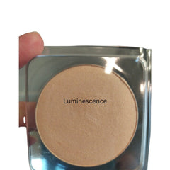 Face powder compact with tan powder, clear plastic case, and "Luminescence" text