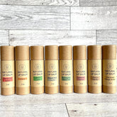 Natural lip balm tubes, brown cardboard, colorful flavor labels, Kind Home & Beauty Co.