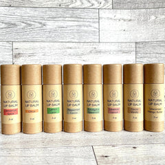Natural lip balm tubes, brown cardboard, colorful flavor labels, Kind Home & Beauty Co.