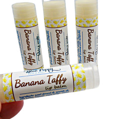 Lip balm tubes with yellow banana pattern and Blue Poppy Bath & Body text visible on white label