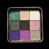 Eyeshadow palette with multiple colors, metallic finish, in a gold-tone compact