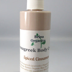 Body cream bottle with white label, light brown body, and white cap, Brina Organics text visible