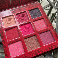 Eyeshadow palette with red and pink shades, embossed design, and a decorative red case