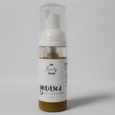 Facial cleanser bottle with white label, clear plastic, and "untitled.beauty" text