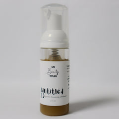 Facial cleanser bottle with white label, clear plastic, and "untitled.beauty" text